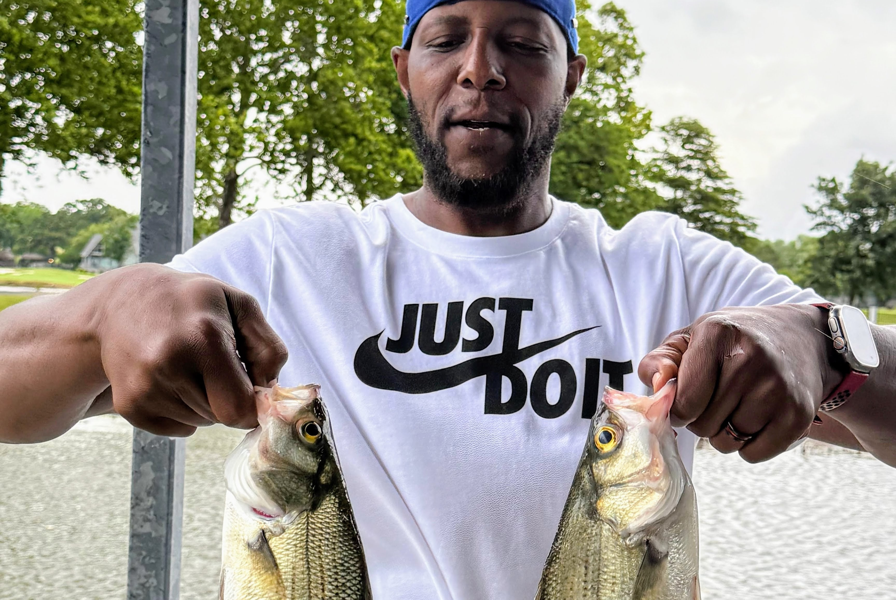 Yusef Dibbles holding two fish